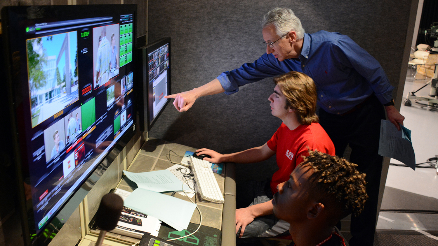 man pointing at monitor