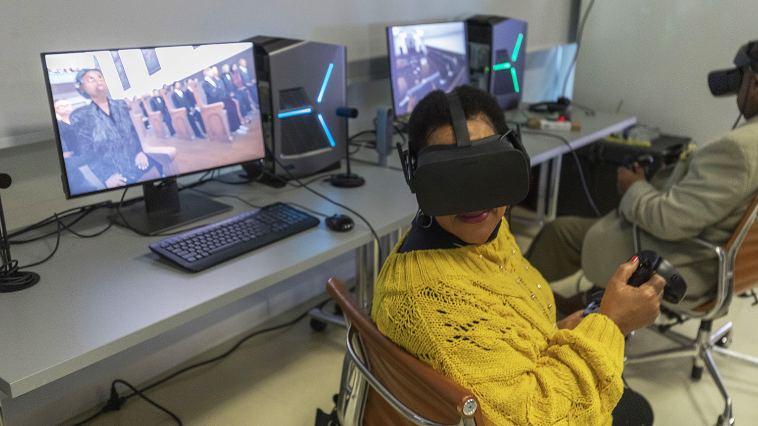 woman in yellow sweater sitting with VR headset on