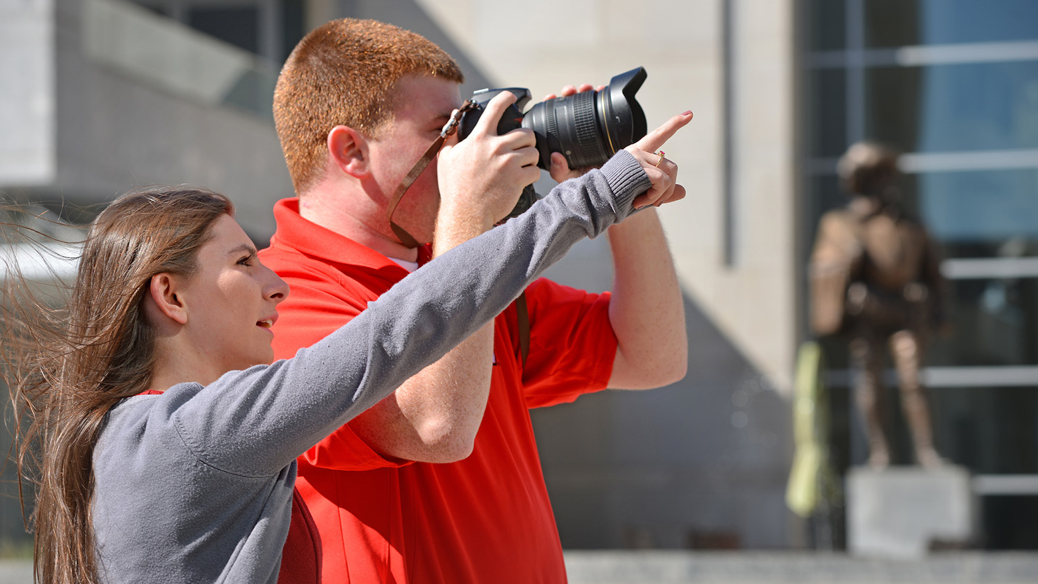 students take photos in downtown Raleigh