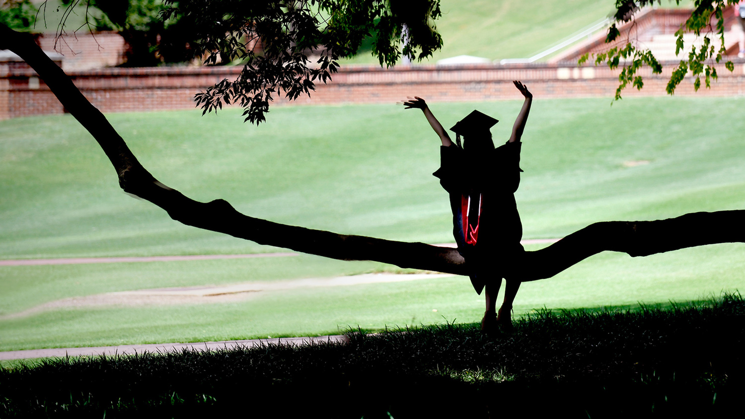 A graduate student poses for photos at the Court of North Carolina.